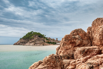 Fototapeta premium Tossa De Mar, Catalonia, Spain. A picturesque town with a fortress, with beautiful beaches and clean turquoise water in cozy bays near Barcelona. Famous tourist destination Costa Brava.