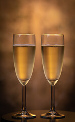 Champagne glasses over holiday bokeh blinking background, glasses with sparkling wine, celebration, party
