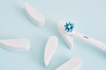 electric toothbrush on a blue background, which brushes are more effective in cleaning the oral cavity