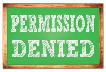 PERMISSION DENIED words on green wooden frame school blackboard