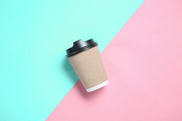 Cardboard coffee cup on blue pink pastel background
