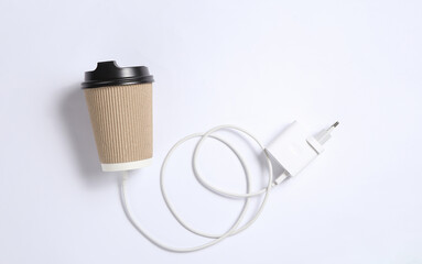 Cardboard coffee cup with charger on white background