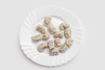 Fototapeta na wymiar Pelmeni. Meat dumplings on a white plate. Good nutrition. Healthy food. Flat lay. Photo