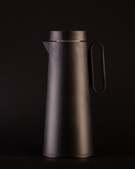 vintage black thermos in scandinavian design isolated on black background
