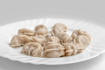 Fototapeta na wymiar Pelmeni. Meat dumplings on a white plate. Good nutrition. Healthy food. Photo