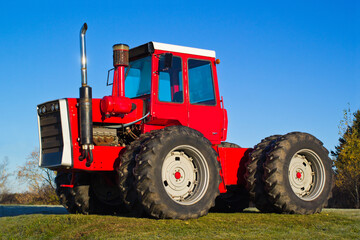 Red four-wheel drive farm tractor and blue sky