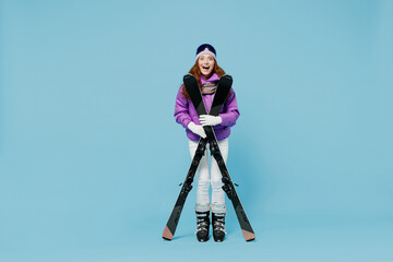 Full size skier shocked happy cheerful fun woman in warm purple padded windbreaker jacket goggles...