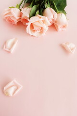 Flowers background.Pink roses  frame top view on pink background with copy space.  Poster