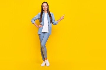 Fototapeta na wymiar Full length photo of funny young lady index ad wear jeans shirt shoes isolated over yellow color background