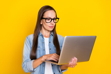 Photo of young attractive woman chatting watch seminar webinar isolated over yellow color background