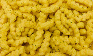 red lentil chips with green onions close-up - food background