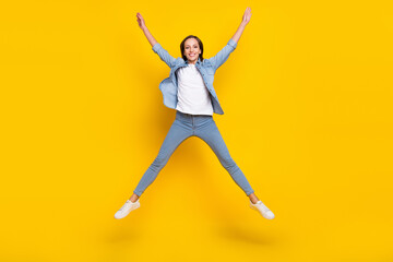 Full size photo of young lovely woman good mood jump fly casual outfit isolated over yellow color background