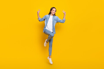 Fototapeta na wymiar Full size photo of young cheerful lady show fingers cool v-symbol jump isolated over yellow color background