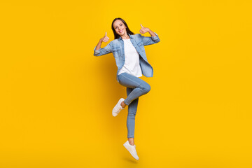 Fototapeta na wymiar Full length photo of young woman jump up show thumbs-up ads decision feedback isolated over yellow color background