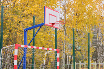 Fototapeta na wymiar Outdoor sports ground. A basketball shield and ring, Active healthy games. Beautiful autumn landscape.