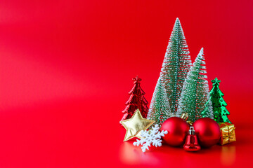 Christmas tree and baubles on red background new year  holiday celebration concept