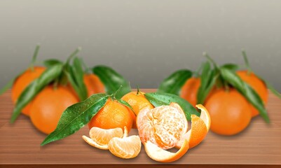 Fresh mandarin oranges fruit or tangerines with leaves on a desk