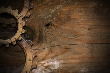 Group of three wooden cogwheels (cog wheels - gears) on a brown wooden plank with copy space. Lumber industry concept. Background. 