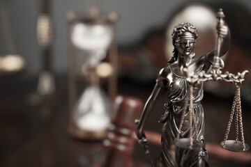 Fototapeta na wymiar Judge office. Law and justice symbols composition: judge’s gavel, Themis sculpture and scale.