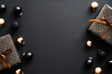 Black Christmas background with gifts and Xmas baubles. Christmas frame, New Year postcard...
