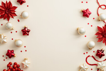 Merry Christmas and Happy New Year background with red ornaments, ribbon, baubles, confetti on pastel beige table. Flat lay, top view, copy space. Xmas postcard template.