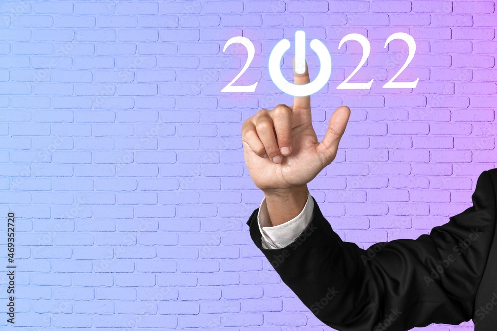 Poster Businessman pointing digital 2022 icon on the neon background.