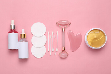 Set for facial care on a pink background. Flat lay beauty composition. Skin care, lifting face concept