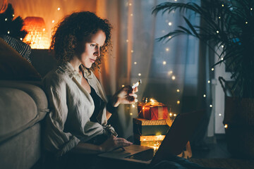 Woman doing online Christmas shopping at home.