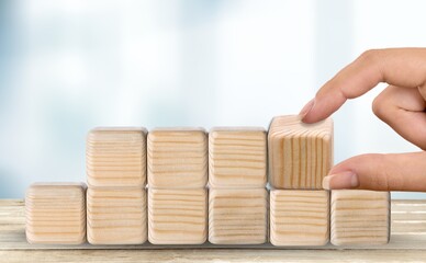 2022 trend concept. Hand flip wooden cube change on the desk