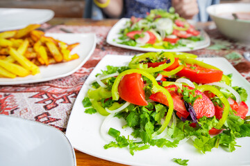 A simple summer salad with tomatoes and greens is a healthy snack