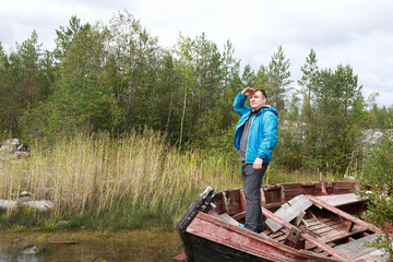 Man standing in old wooden boat