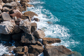 Beating sea waves against rocks. Top view.