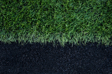 Artificial grass arena with finely ground black rubber. Texture of a rubber treadmill