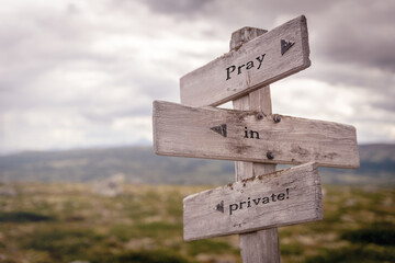 pray in private text on wooden sign outdoors in nature. Religious and christianity quotes.