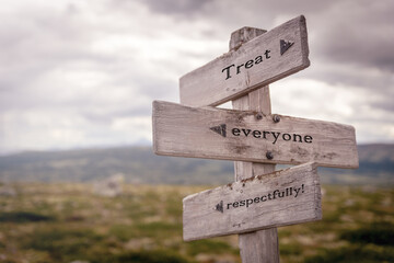 treat everyone respectfully text on wooden sign outdoors in nature. Religious and christianity quotes.