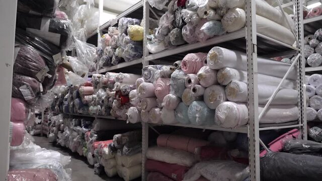View of a rack with rolls of multicolored fabrics