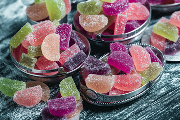 Dessert marmalade in the form of lemon and orange slices. The sweetness of jelly candy.