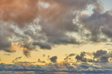 Colorful clouds in the setting sky as a background.