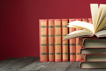 Open book, hardback books on wooden table. Back to school. Copy space