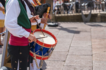 Fototapeta na wymiar Man in Asturian costume playing the drum in a square in the city of Oviedo, Uvieu, in Asturias.