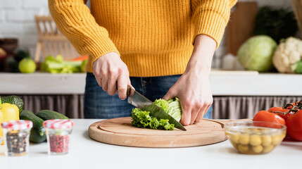 woman preparing greek salad in kitchen