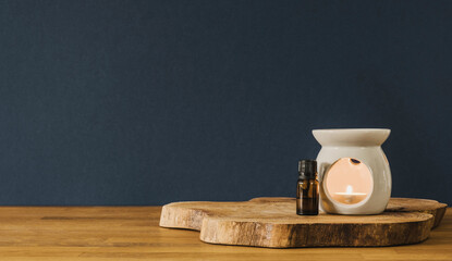 Glass bottle and candle on wooden desk with copy space