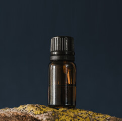 Brown glass bottle with liquid on dark background