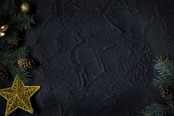 Christmas background with fir tree and decor on dark background. Top view with copy space