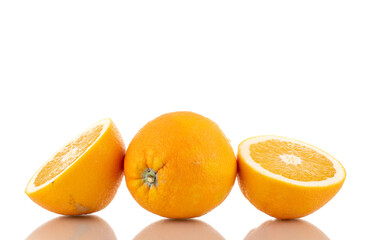 Two halves and one whole juicy bright yellow orange, close-up, isolated on white.