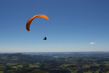 Paraglider in a beatiful day to fly. Clear and windy sky for sports. Flying over the mountains.