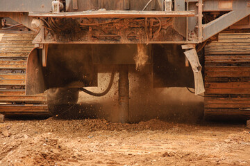 Fototapeta na wymiar Preparation of a blast in an iron ore quarry, drilling wells with a drilling rig. Drilling in red rock. Technologies of iron ore mining