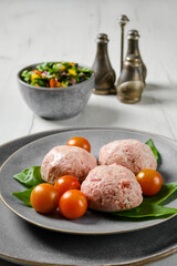 Semifinished frozen veal meatballs on a plate