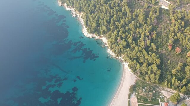 Aerial panoramic view over Milia beach in Skopelos island, against a cloudy sky in Sporades, Greece