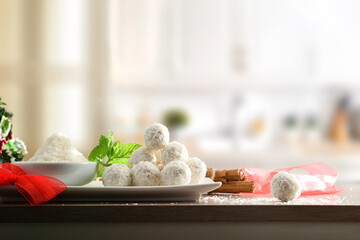 Kitchen table with coconut balls prepared for event kitchen background